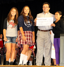 Pictured, Cesar Armendariz (center right), accepts the check for White Memorial Medical Center from fifth grade students (from left) Giselle Duran, Jeanette Almaraz and Jayca Linares. Photo/Jon Nalick