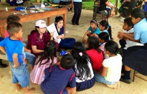 Global Medicine students Niloofar Sheshebor (left) and Natalie Reyes (right) teach the children of Popa Uno, Panama, about proper wound care during the students’ time overseas as part of the USC Master of Science in Global Medicine program. (Photo/Karissa Nguyen)