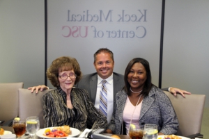 Keck Hospital of USC and USC Norris Cancer Hospital CEO, Scott Evans, PharmD, and Luanda Grazette (right), MD, MPH, associate professor of clinical medicine at the Keck School of USC, celebrate the gift of a Cheetah NICOM monitor from Bernice Christenson (left) at a special luncheon in Christenson’s honor. (Photo/Amy E. Hamaker)