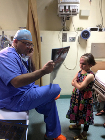 Jeffrey Hammoudeh, director of the Jaw Deformities Center at CHLA, reviews the X-ray of young Syrian girl during a recent trip to Jordan.  (Photo/Janet Dotson)