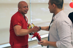 Nurse Victor Dimacali, left, is congratulated by a colleague after being named Nurse of the Year.