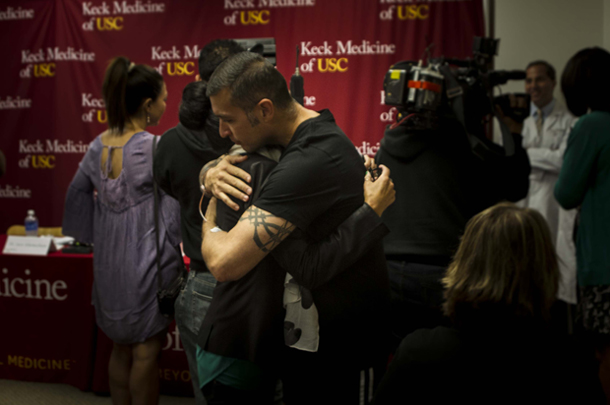 Organ donor Javier Tiscareno hugs wife Carmen just a week after donating 60 percent of his liver to save a Sheriff's Department colleague. 