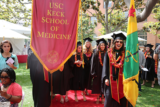 Leslie Cardoza, right, stands in line before the Primary Care Physician Assistant satellite commencement ceremony May 13, 2016 on the University Park Campus.
