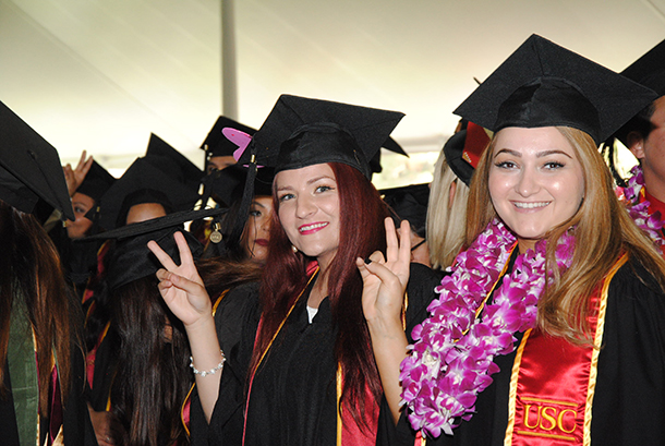 Graduates show their Victory signs at the Herman Ostrow School of Dentistry of USC's satellite ceremony May 13 on the University Park Campus.