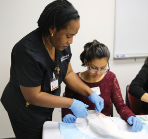 Chinwe Thomas, a PA student, works with a USC PA Pipeline participant as part of a workshop that focuses on inspiring students to pursue careers in health care and serve underserved communities.