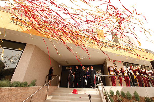 Confetti streamers fly during a ribbon-cutting ceremony for the Malcolm and Barbara Currie Residence Hall opening, held Aug. 25 on the Health Sciences Campus. (Photo/Steve Cohn)