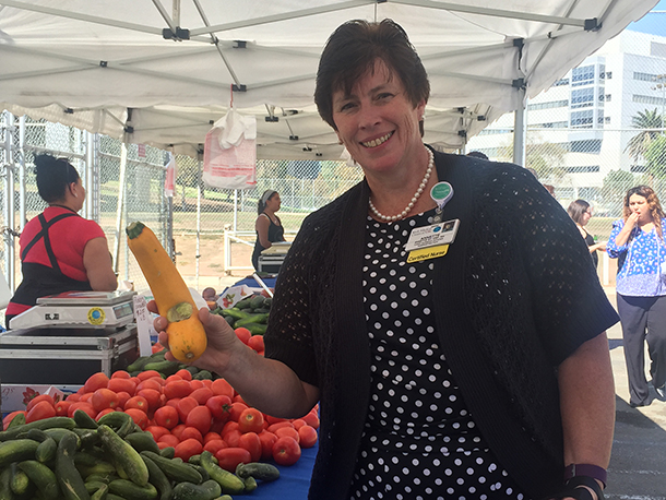Chief Nursing Officer Annette Sy checks out the produce at the new Keck Farmers Market, Oct. 4 at Hazard Park. (Photo/Virginia Baca)