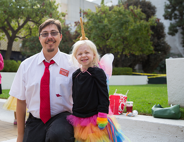 James Walker, left, participates in the Halloween parade Oct. 31 on the Health Sciences Campus with his daughter Mirjana, who is dressed as a unicorn with wings. (Photo/Ricardo Carrasco III)