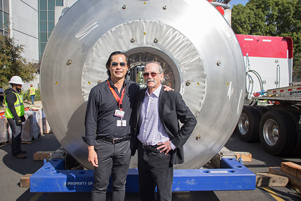 Meng Law, left, and Arthur Toga stand in front of a 7T magnetic resonance imaging (MRI) machine, before it is installed in USC Stevens Hall on Feb. 4, 2017. (Photo/Ricardo Carrasco III)