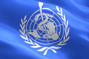 A flag bears the World Health Organization symbol.