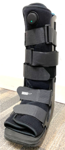 A removable foot boot bears a small circular casing at the center, near the top.