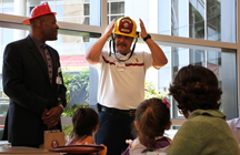  From left, Robert Vance, emergency management officer at Keck Medical Center, and Jim Buck, program coordinator for the Rapid Response Team, deliver advice about household fire safety to children from the USC Child Care Center.  Photo/Jon Nalick