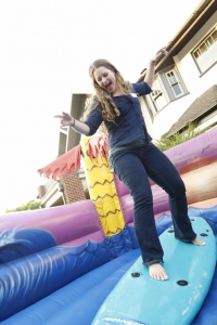 First-year Keck School student Anna Goebel from Salinas, Calif., shows off her surfing skills at the First-Year Students Welcome Reception on Aug. 13.  (Photo/Steve Cohn)