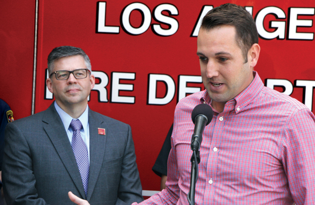 Marathon runner and heart-attack survivor Jode Lebeda (right) thanks Keck Medicine of USC volunteers for his survival at an April 21 press conference at Los Angeles Fire Station 3 in Los Angeles. Moments later, Glenn Ault (left), medical director of the ASICS LA Marathon and associate dean of clinical administration, Keck School of Medicine of USC, took the podium to say, “I think I can speak for everyone when I say we’re all pleased with the outcome.” (Photo/Jon Nalick)