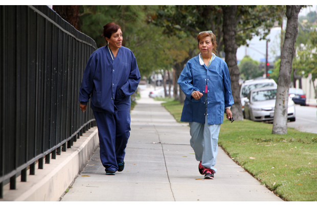 As part of a wellness program sponsored by Keck Medicine of USC – Pasadena, employees are encouraged to walk one of several courses of varying lengths around and through Huntington Memorial Hospital. Above, Tina Hernandez (left) and Carolina Garcia go on their daily walk along a two-mile course that skirts the perimeter of the hospital. (Photo/Jon Nalick)