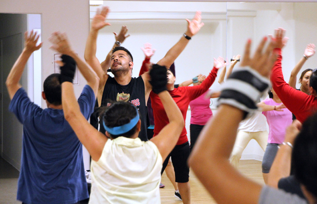 Instructor Andres Martinez leads a dance/cardio class under the auspices of The Wellness Center at the Historic General Hospital, which opened in March. The center houses several like-minded nonprofit organizations with the common goal of improving the health of residents in nearby communities. (Photo/Jon Nalick)