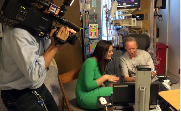 Keck Hospital of USC patient Jim McDermott and Fox 11 News reporter Christine O'Donnell view McDermott's son's graduation on a laptop. (Photo/Leslie Ridgeway) 