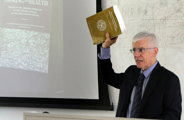 Jonathan Samet, chair of the Department of Preventive Medicine at the Keck School of Medicine of USC, displays a new Surgeon General’s report that describes the devastating consequences of tobacco use in the United States over the last 50 years. (Photo/Jon Nalick)