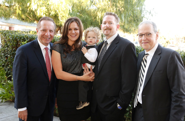 From left are: Dean Puliafito; Kelly, Shane and Patrick Lundie; and John K. Niparko. At the event, Kelly Lundie shared her story about her son Shane’s journey to hearing. USC surgeons and audiologists — including Niparko — performed the boy’s cochlear implant surgery. 