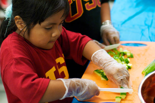 Young participants in Fit Families learn to prepare healthy foods such as vegetables during the nutritional training portion of a recent Saturday session for East L.A.