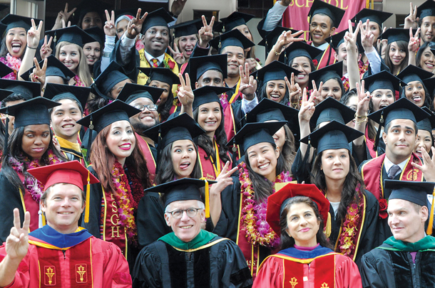 Graduates in the Health Promotion and Disease Prevention and Global Health programs let their emotions show in a May 15, 2015 group photo with faculty. 