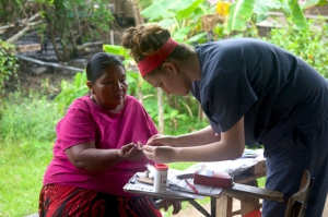 Dilara Onur, who recently earned a master’s degree in Global Medicine at USC, performs a finger prick test on a woman in Bocas del Toro, Panama, to measure her hemoglobin.