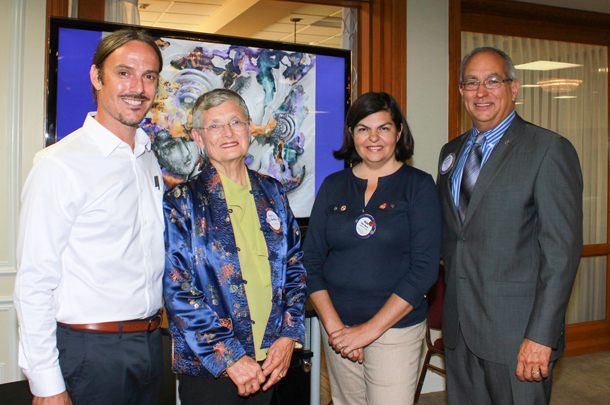 The Oct. 1 presentation in San Marino included Mike Becker, left, and Lynn Crandall of the IGM Art Gallery, shown with Gilda Moshir, president pro tem, and Mike Driebe, president, of the Rotary Club of San Marino. An image of Nickki Anand's painting, 