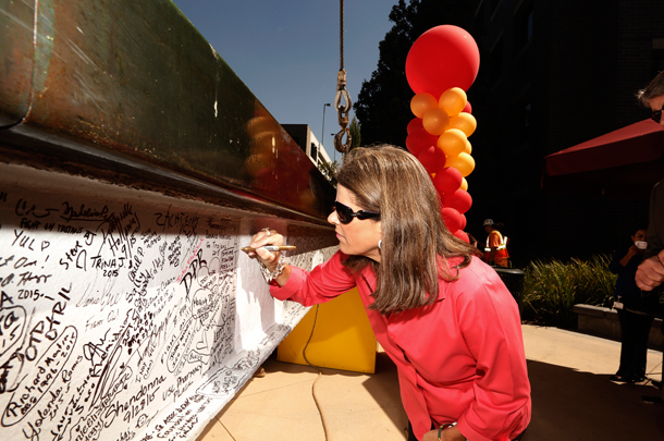 Lisa Hansen, who chairs the Board of the Norris Foundation and is the daughter of long-standing supporter Harlyne Norris, was among those who signed their names and added messages to the last steel beam before it was hoisted into place.