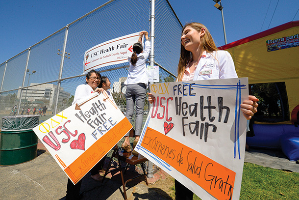 USC School of Pharmacy students direct visitors to the 2016 Health and Fitness Fair, held March 27, 2016, at Hazard Park. (USC Photo/Gus Ruelas)
