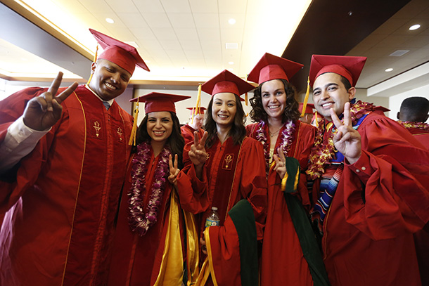 Graduates show their Victory signs before the Keck School of Medicine of USC MD/PhD and MD commencement ceremony May 14, 2016 at the Galen Center.