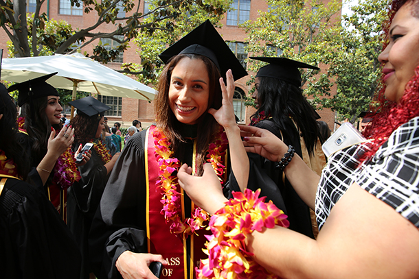 Isabel Alegria recieves a flower lei before the Primary Care Physician Assistant satellite commencement ceremony May 13, 2016 on the University Park Campus.