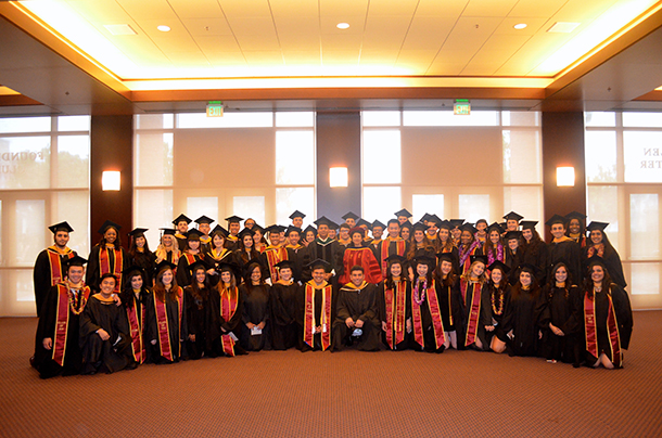 Graduates from the Master of Science in Global Medicine program take a photo with Keck School of Medicine of USC Interim Dean Rohit Varma and Elahe Nezami, associate dean for undergraduate, masters and professional programs, during the satellite commencement ceremony May 14 at the Galen Center.