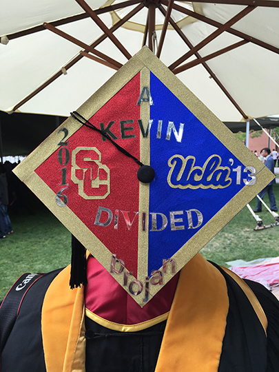 Kevin Cabrera, a Master of Science in Global Medicine graduate, shows off his decorated graduation cap after commencement, held May 14, 2016 at the University Park Campus.