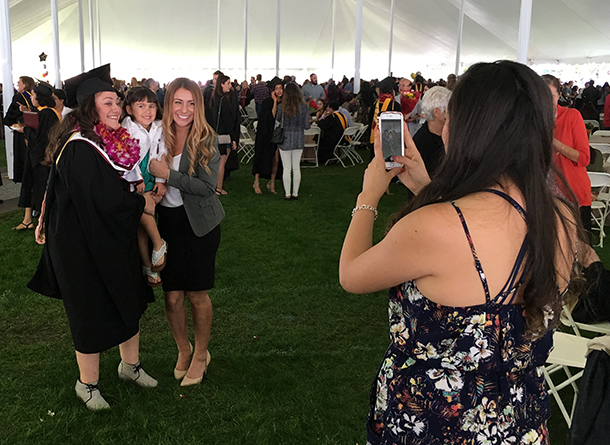 Beatriz Adriana Barajas, a Keck School of Medicine of USC master of public health graduate, takes a photo with family members during a commencement reception May 14, 2016 at McCarthy Quad on the University Park Campus.
