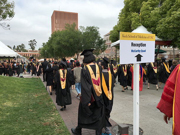 Keck School of Medicine of USC PhD and master's degree graduates walk from the Galen Center to McCarthy Quad on the University Park Campus for a reception after the commencement ceremony on May 14, 2016.