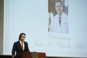 Kevin Niparko speaks during a memorial for his father, John K. Niparko, May 10 at Mayer Auditorium on the Health Sciences Campus.