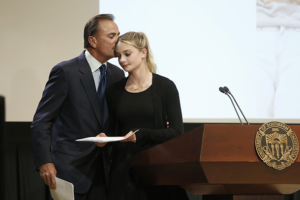 Rick Caruso comforts his daughter Gianna after she spoke at a memorial for John Niparko, held May 10 at Mayer Auditorium on the Health Sciences Campus.