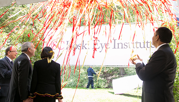 From left, USC President C. L. Max Nikias, Edward Roski, Gayle Roski and Rohit Varma look on as confetti streamers fall during the naming celebration of the USC Gayle and Edward Roski Eye Institute on April 28 at Harry and Celeste Pappas Quad on the Health Sciences Campus.