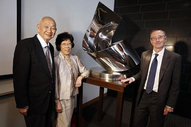 From left, philanthropists Kin-Chung Choi, Amy Choi and USC’s stem cell research center director Andy McMahon stand with a sculpture donated by the Choi Family Foundation, June 10, 2016, on the Health Sciences Campus.