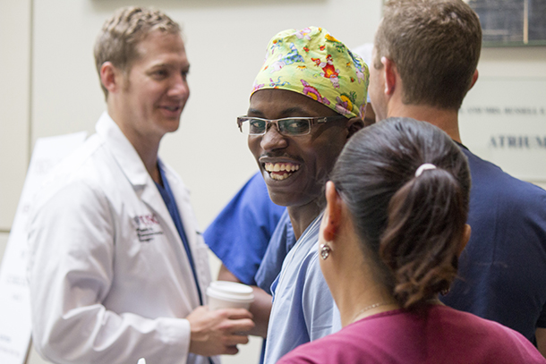 Jean Paul Shumbusho, center, a surgical resident at National University of Rwanda, smiles during a training session May 19. USC faculty and international surgeons exchanged knowledge and honed their skills in a surgical simulation training through Operation Smile, held May 19-21 at the Keck School of Medicine of USC.