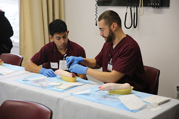 High school student Jose Salazar, left, works with PA student Curtis Ciesinski to learn how to suture in a workshop at a recent USC PA Pipeline event. Outreach like the USC PA Pipeline Program helps recruit students from diverse and disadvantaged backgrounds.