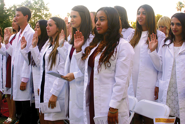 Occupational therapy graduate students recite a pledge during the USC Mrs. T.H. Chan Division of Occupational Science and Occupational Therapy's 2016 White Coat Ceremony, held Aug. 26 on the Health Sciences Campus.