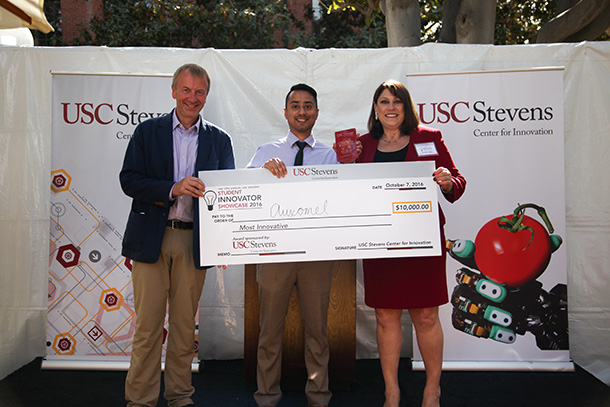 USC student-led startup, Auxomel, won the $10,000 Most Innovative and $2,500 Venture Validation awards at the 10th Annual USC Stevens Student Innovator Showcase held Oct. 7, 2016. Herman Ostrow School of Dentistry of USC student Kaushik Mukherjee received the award from Jennifer Dyer, USC Stevens executive director, and Peter Kuhn, master of ceremonies. 