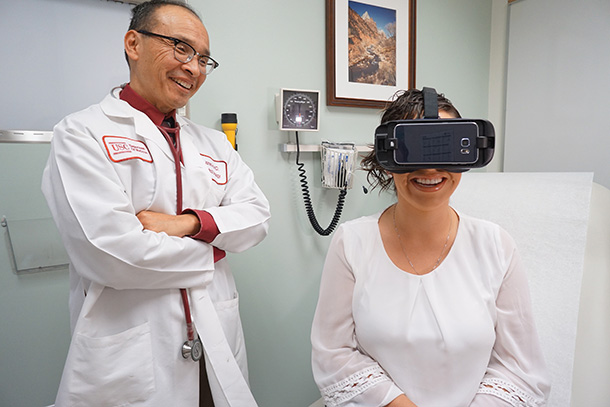 James Hu watches a USC Norris Comprehensive Cancer Center patient experience a new virtual reality treatment.