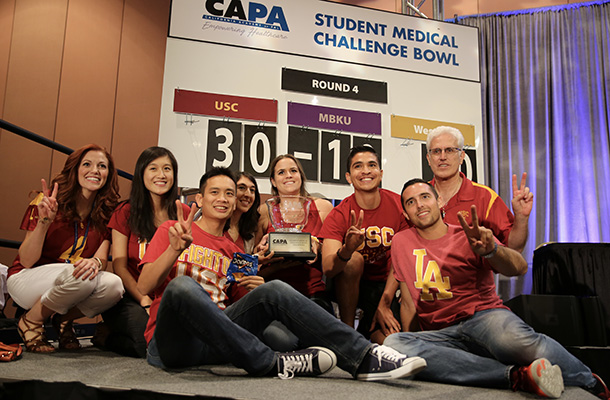 From left, Jennifer Ramos, Jie Zhuang, Matthew Tan, Sarah Nargiso, Nicole Galle, Andrew Luna, Dane Arispe and Christopher P. Forest pose with the California Academy of Physician Assistant Challenge Bowl trophy.