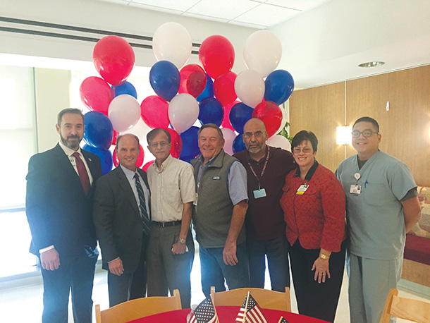 Rod Hanners, CEO of Keck Medical Center of USC and COO of Keck Medicine of USC, second from left, and Annette Sy, chief nursing officer of Keck Medical Center, second from right, join veterans at a breakfast for Keck Medicine employees who served in the armed forces. Hanners is a U.S. Navy veteran.