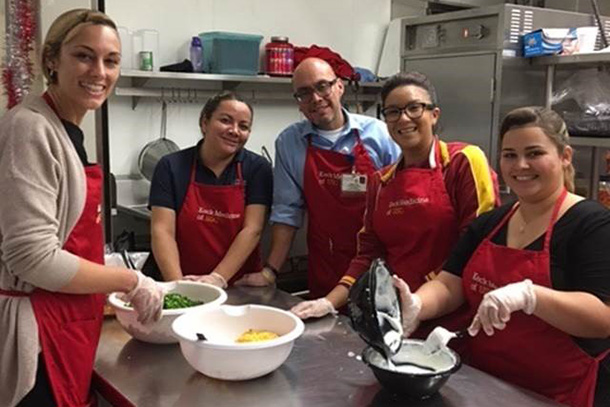 Volunteers work in the kitchen at Dolores Mission in January.