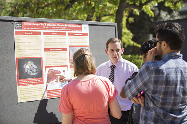 Tyler Toth explains his poster as part of the Keck School of Medicine of USC’s annual Medical Student Research Forum and Poster Day, held April 4 on Pappas Quad.