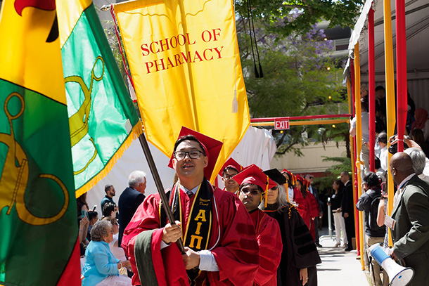 Graduates William Duong and Khan Akram serve as flagbearers during the USC School of Pharmacy commencement ceremony, held May 12 on the Health Sciences Campus.
