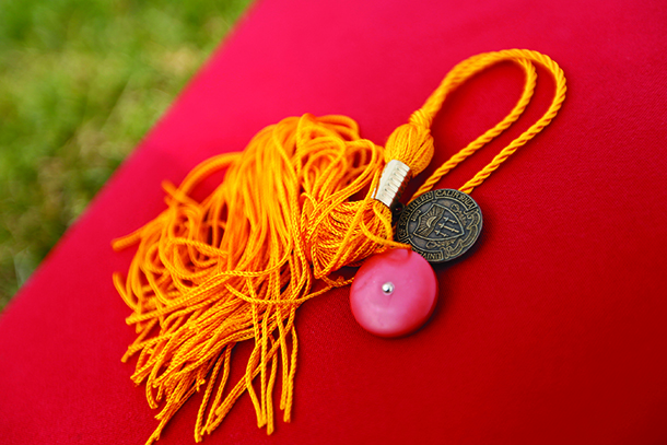 A red mortar board and tassel